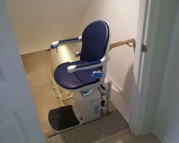Reinforced heavy-duty stairlift with a wide, supportive seat on an indoor staircase