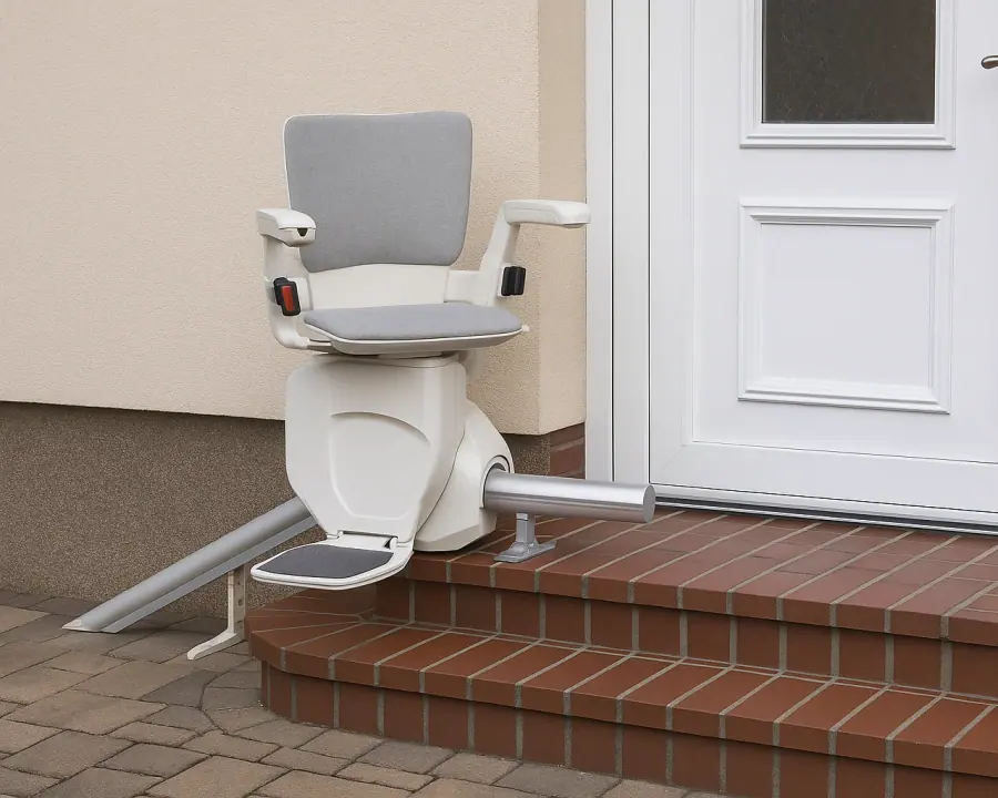 Weatherproof outdoor stairlift mounted on brick front-porch steps beside a white door